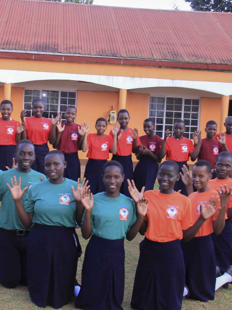 Students kneeling in compound